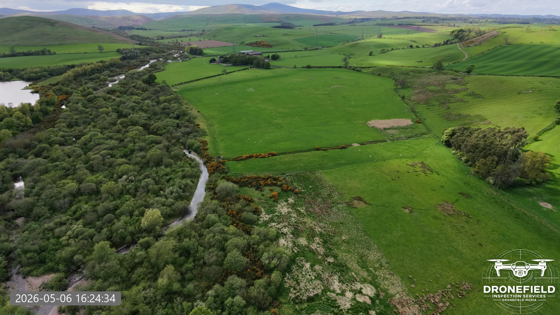 Shotara sample output showing a timestamped and branded drone landscape image